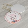 Ornament with village scene, pink-red wreath, with message 'Wishing you a season of love, peace, and happiness