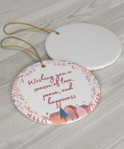 Ornament with village scene, pink-red wreath, with message 'Wishing you a season of love, peace, and happiness