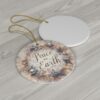 Christmas ornament is designed in a light gray and beige palette with the words Merry Christmas on it.