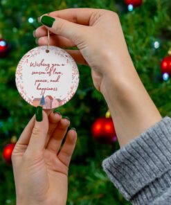 Ornament with village scene, pink-red wreath, with message 'Wishing you a season of love, peace, and happiness