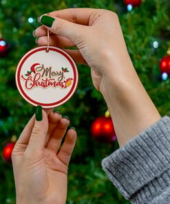 This Christmas ornament showcases the text "Merry Christmas" in an elegant script, accented with holly leaves and berries