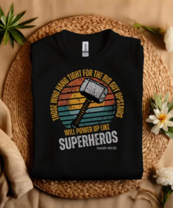 Black Gildan T-shirt folded laying on a straw hat Superhero design