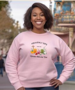 light pink sweatshirt with Three faith-inspired juice glasses: Joyful Juice (orange with a cross), Blessed Berry (pink with a dove), and Graceful Green (green with a fish).