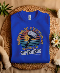 Royal Blue Gildan T-shirt folded laying on a straw hat Superhero design