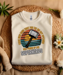 Sand colored Gildan T-shirt folded laying on a straw hat Superhero design