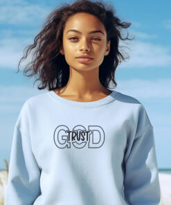 Woman wearing a light blue sweatsheart with Trust in God on the front Trust in God