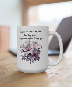 White ceramic mug with the phrase "Consider the Lilies of the Field" and floral accents. Christian mug with a Bible verse for daily inspiration.