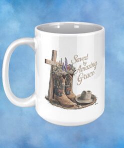 Coffee mug with a cross and cowboy hat and boots filled with flowers with Saved by Grace on it