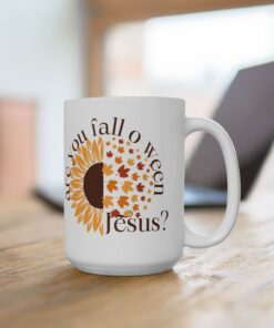 White ceramic coffee mug with the phrase “Are You Fall-o-Ween Jesus?” in festive fall colors. Features a playful Christian theme for fall.