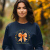 Woman in Navy Colored Gildan 1800 Sweatshirt with Design that says His Grace Falls Like The Autumn Leaves