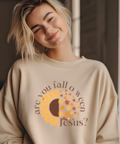 Woman wearing sand colored Gildan 1800 sweatshirt with Are You Fall O Ween Jesus on it