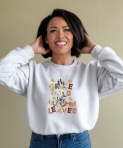 An African American woman wearing a white Gildan 1800 sweatshirt His Grace Falls Like Autumn Leaves