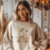 Woman wearing a Gildan 1800 sand colored sweatshirt His Grace Falls Like Autumn Leaves