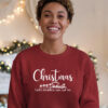 A-young-woman-wearing-a-red-Gildan-1800-sweatshirt-that-saysChristmas-Gods-Relentless-Love-For-Us