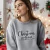 A-young-woman-wearing-a-sport-grey-Gildan-1800-sweatshirt-that-saysChristmas-Gods-Relentless-Love-For-Us