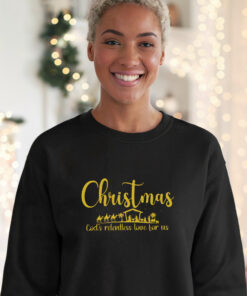 Young-woman-wearing-a-black-Gildan-1800-sweatshirt-that-saysChristmas-Gods-Relentless-Love-For-Us