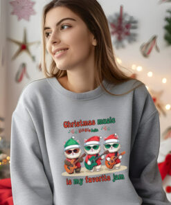 a woman wearing a sport gray Gildan 1800 sweatshirt that says Christmas music is my favorite jam