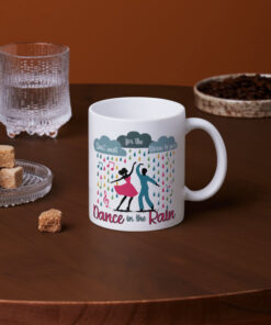 Colorful coffee mug featuring dancers in the rain with the inspirational phrase 