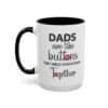 15 oz White ceramic mug with black rim and handle featuring the phrase “Dads are like buttons they hold everything together” left view