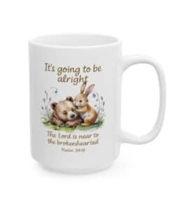 15 oz Scripture Ceramic Mug - It's Going to Be Alright Christian Comfort Mug with watercolor bear and bunny design, pastel flowers, and the scripture “The Lord is near to the brokenhearted Psalm 34:18 left view
