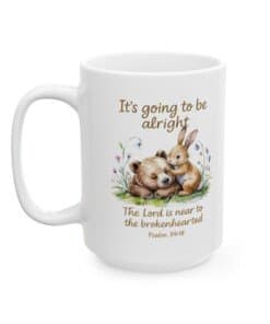 15 oz Scripture Ceramic Mug - It's Going to Be Alright Christian Comfort Mug with watercolor bear and bunny design, pastel flowers, and the scripture “The Lord is near to the brokenhearted Psalm 34:18 Right view