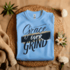 Caroline colored Gildan 5000 Grace Over Grind t-shirt features bold calligraphy, gold and black brushstrokes, and an inspirational Christian faith message
