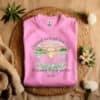 Pink Flat fold Children Are a Gift From God Floral Christian T-Shirt featuring a watercolor sunrise, handprint flowers, and faith-based quote.