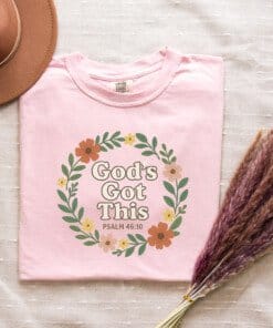 Flay-lay-of-a-blossom-colored-Comfort-Colors-1717-T-shirt-God-Got-This.