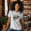 Ash Colored Gildan 5000 Grace Over Grind t-shirt features bold calligraphy, gold and black brushstrokes, and an inspirational Christian faith message